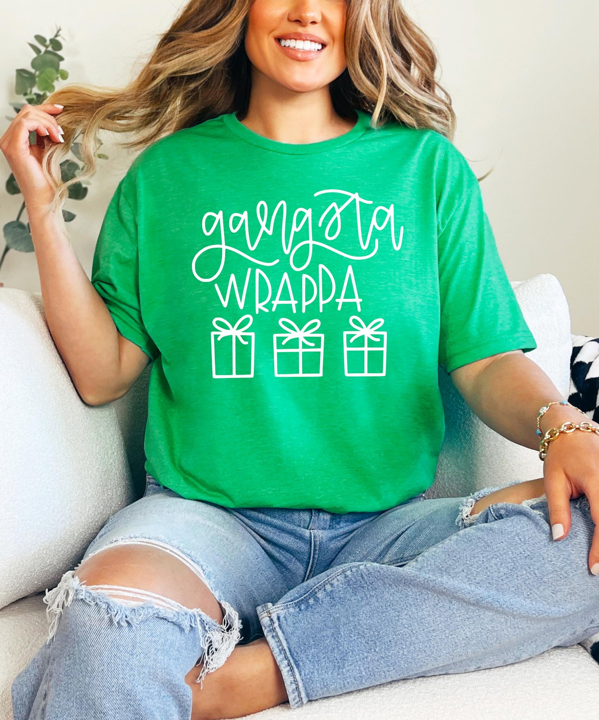 Close-up of Gangsta Wrappa holiday graphic print on red women's Christmas tee