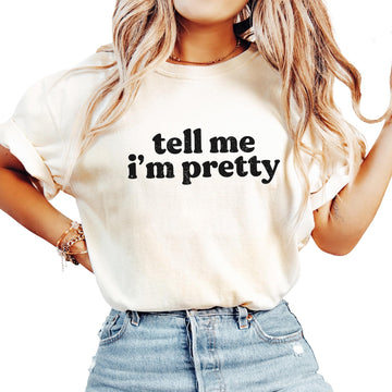 Women's ivory graphic tee with 'Tell Me I'm Pretty' text design, front view
