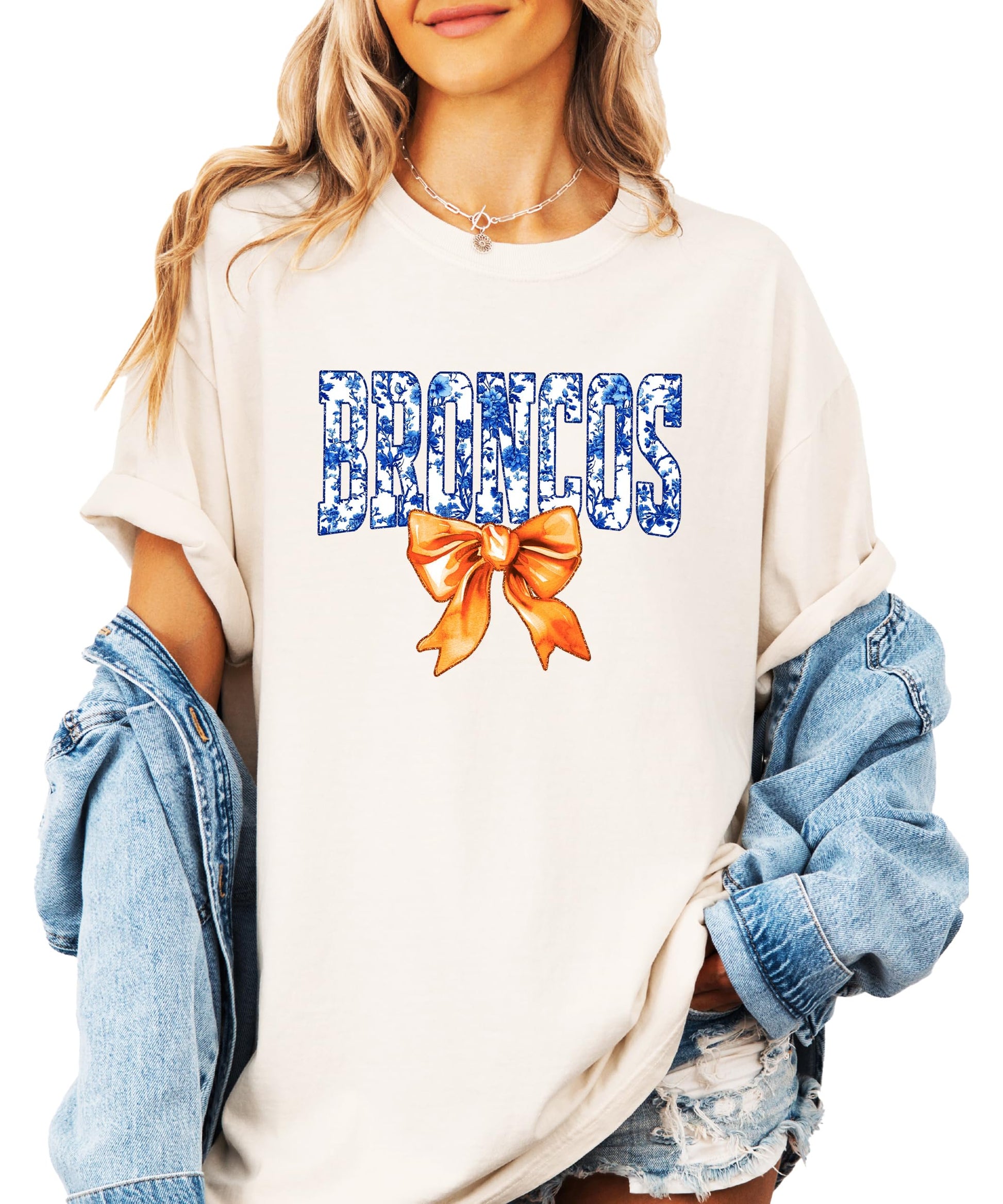Front view of Broncos fan graphic tee featuring floral-filled team lettering and statement bow