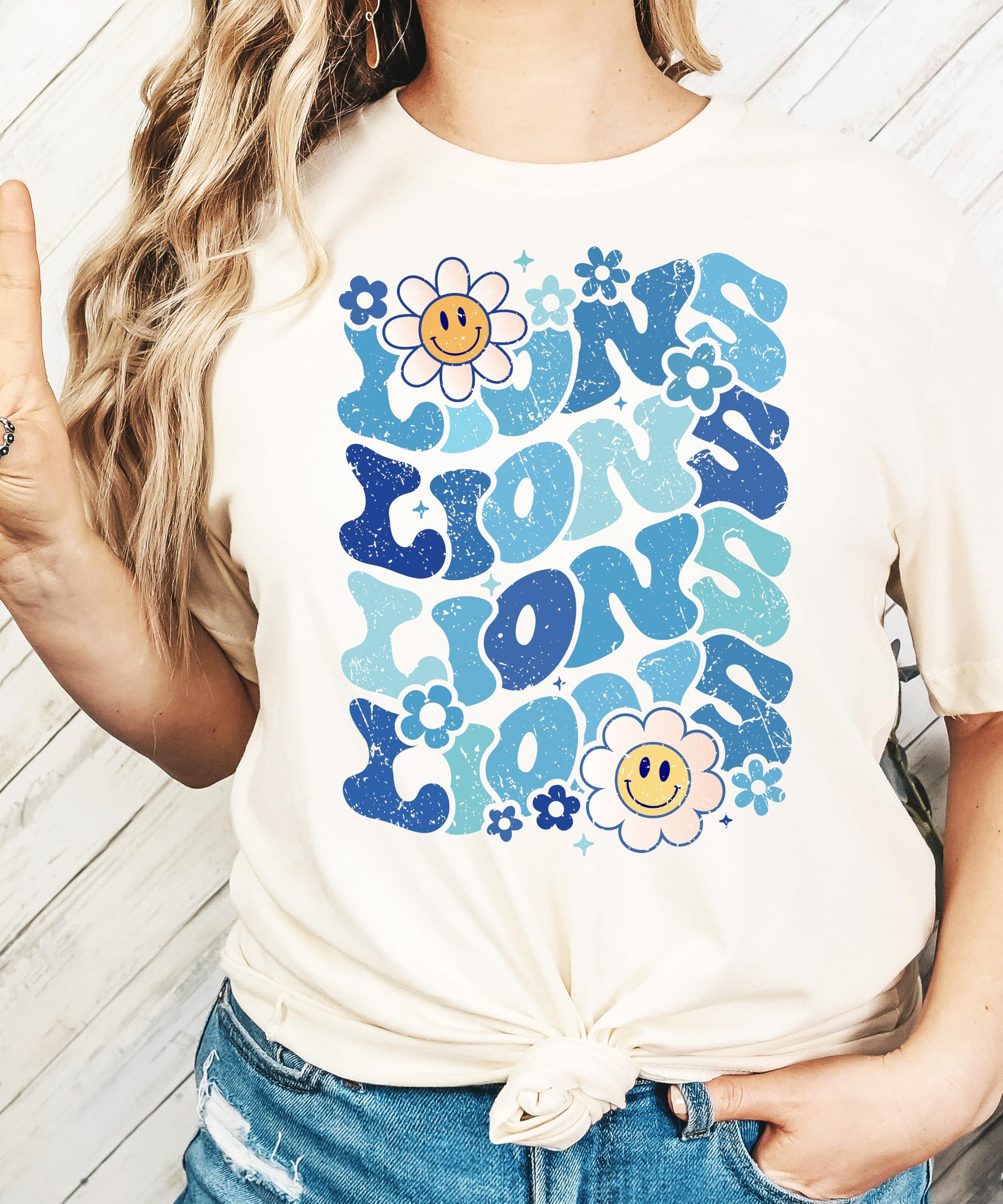 Woman wearing blue Lions mascot graphic tee casual styling