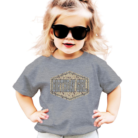 Side or back view of camo birthday girl natural graphic tee