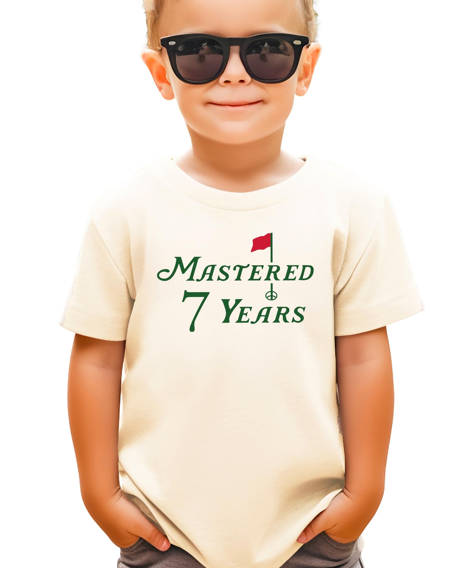 Natural kids tee with Mastered 7 Years golf-themed birthday graphic for boys and girls
