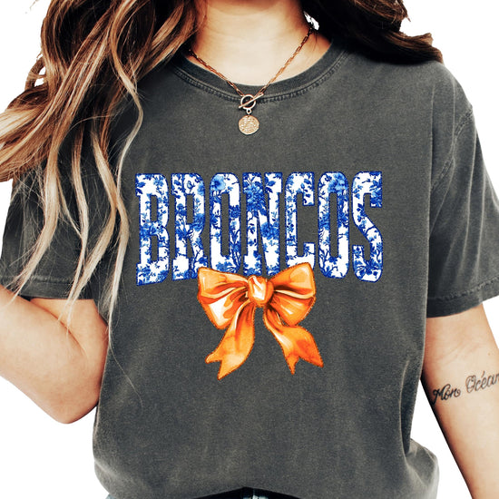Close-up of Broncos floral bow design on women's casual graphic tee