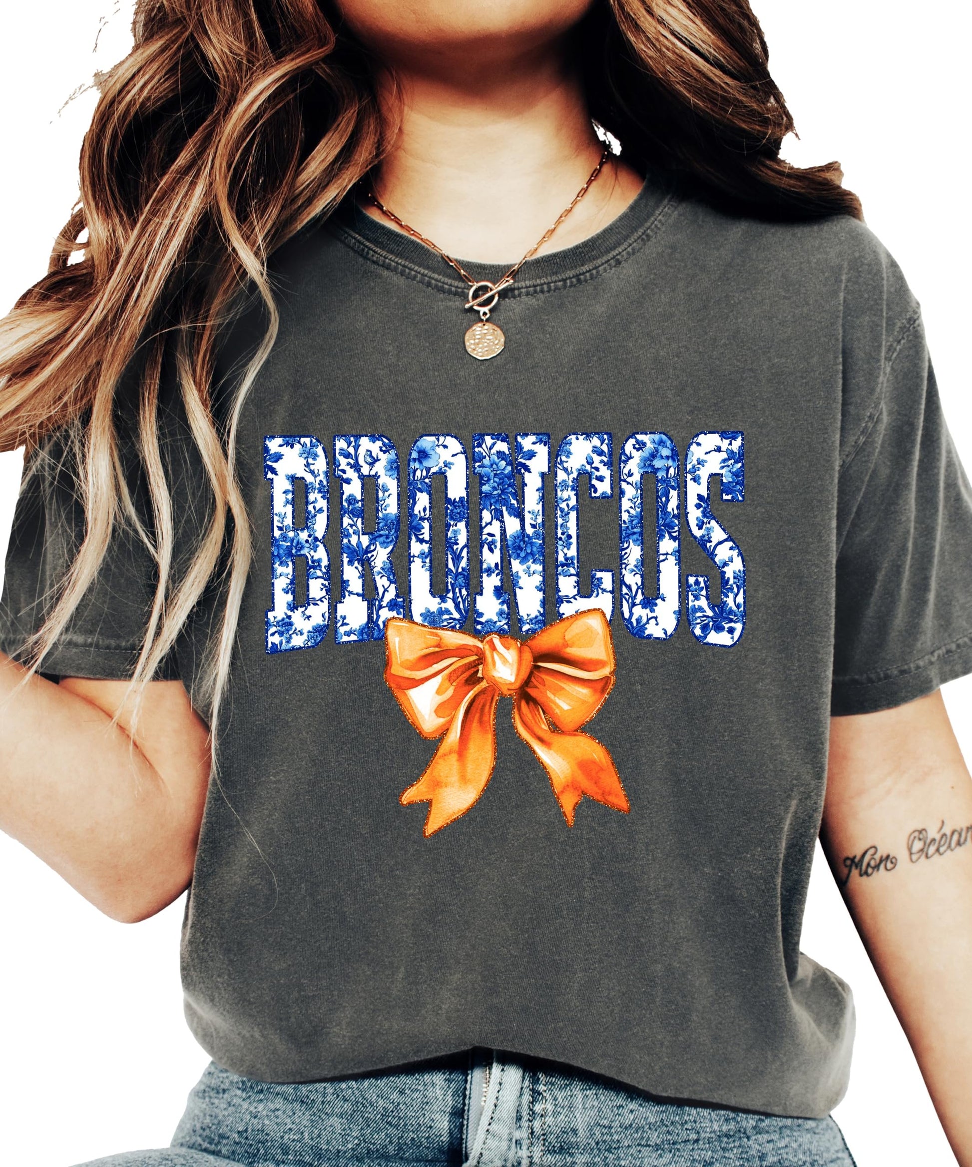 Close-up of Broncos floral bow design on women's casual graphic tee