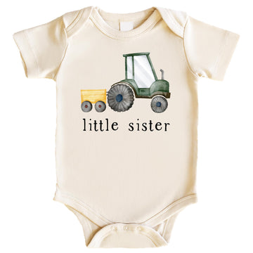 Natural baby bodysuit with little sister farm tractor graphic for sibling reveal or birth announcement
