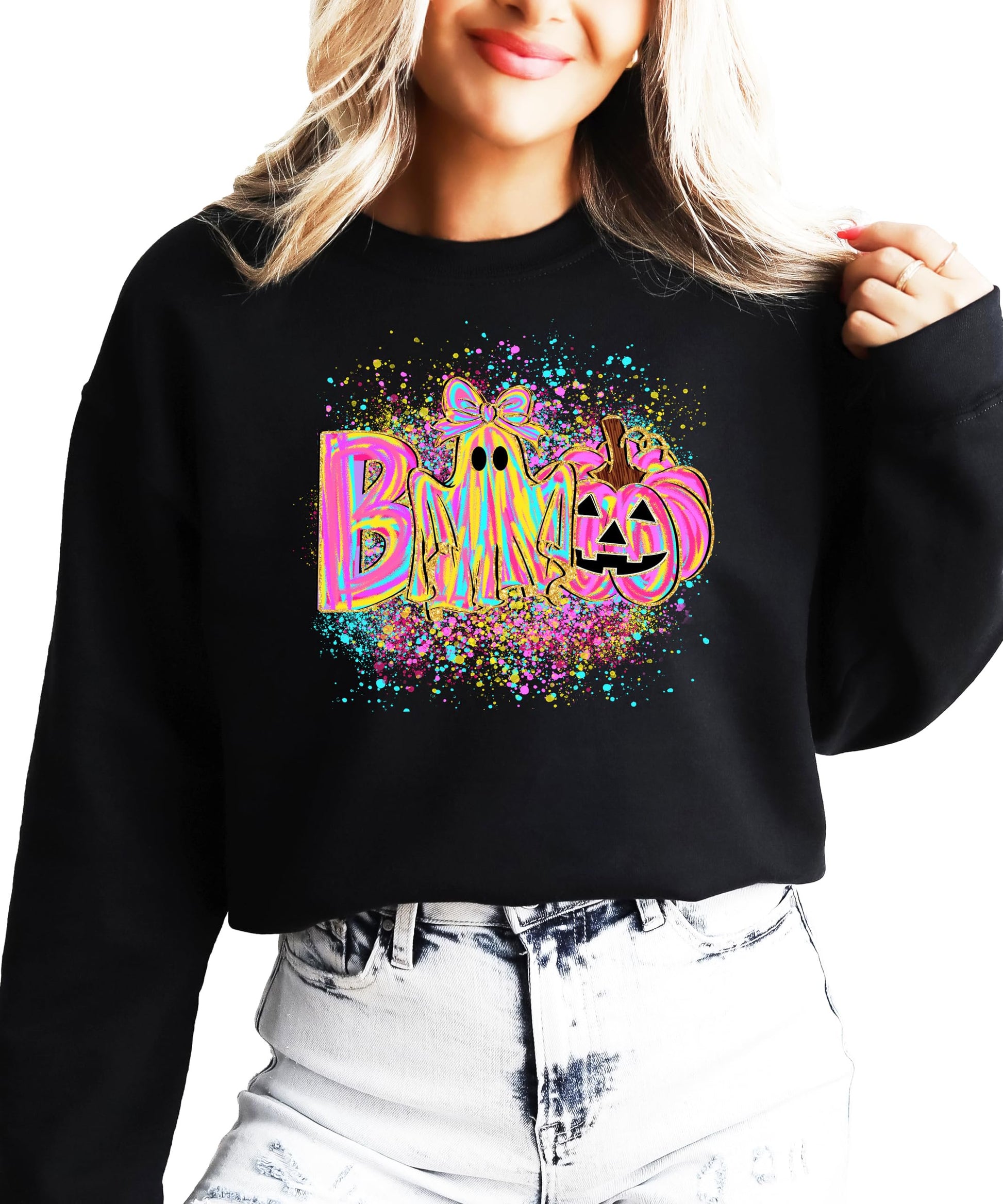 Close-up of neon BOO graphic sweatshirt showing ghost with bow and pumpkin design detail