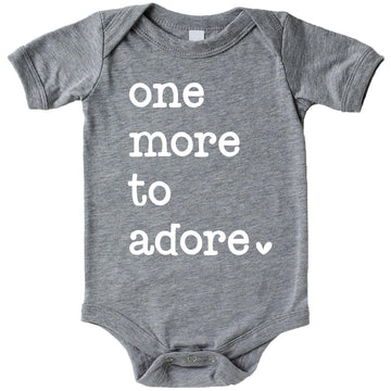 One More to Adore reveal bodysuit displayed for newborn take-home or pregnancy announcement photo