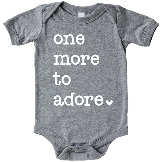One More to Adore reveal bodysuit displayed for newborn take-home or pregnancy announcement photo