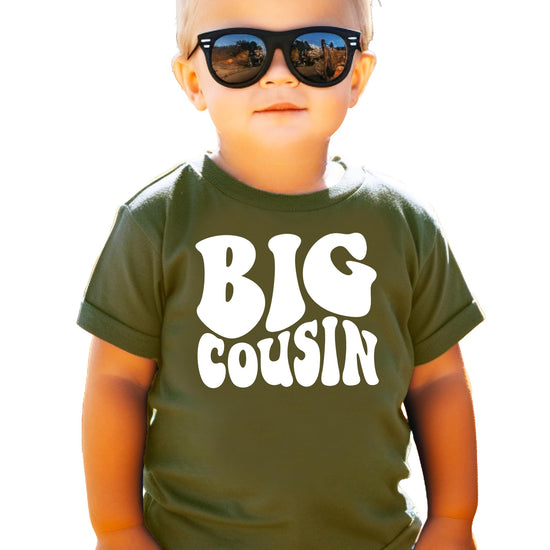 Big Cousin youth graphic tee shown from the back on military green shirt