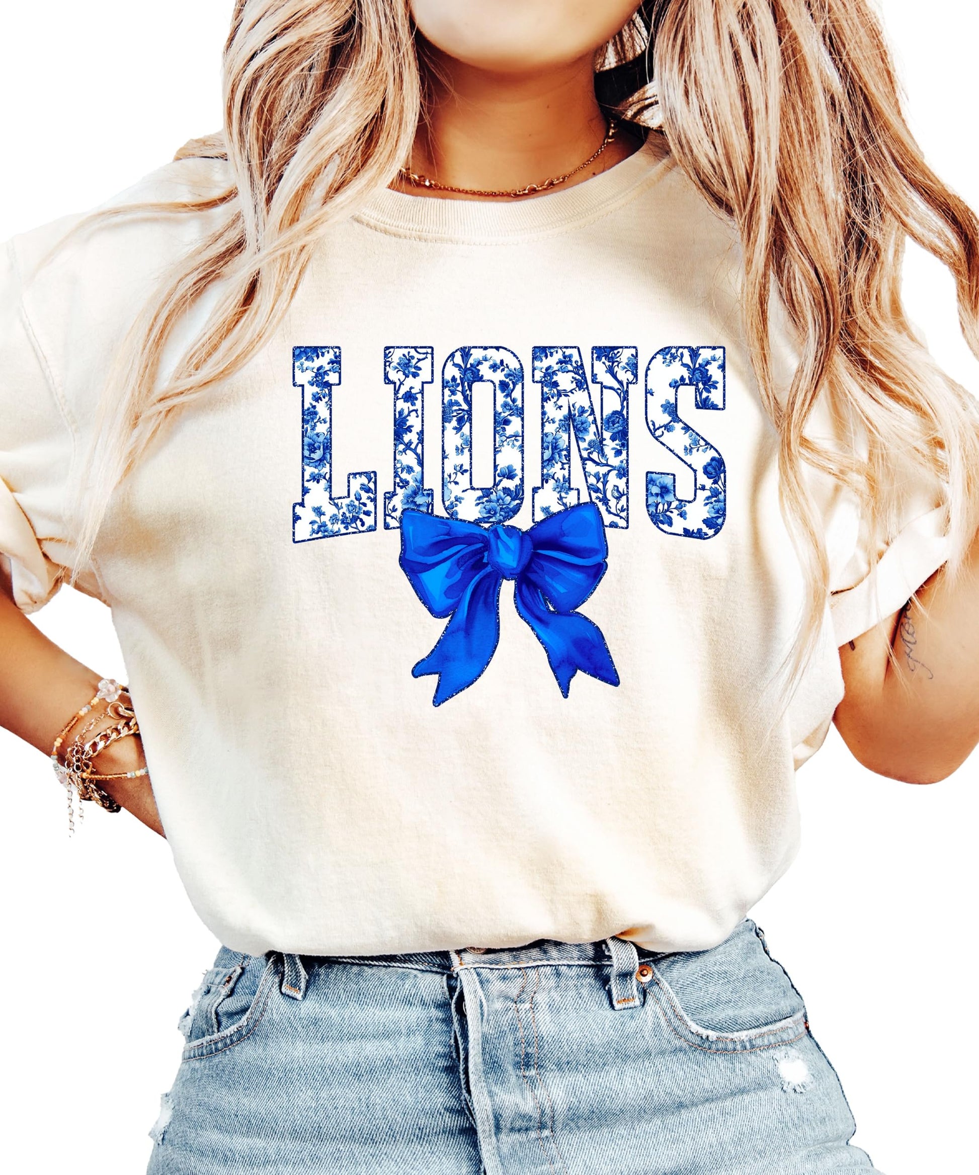 Woman wearing ivory Lions school spirit tee with floral graphics