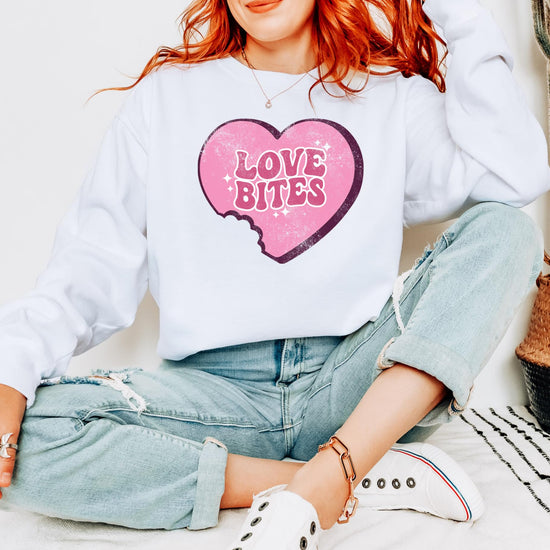 Close-up of Love Bites heart graphic print on a Valentine's Day crewneck sweatshirt