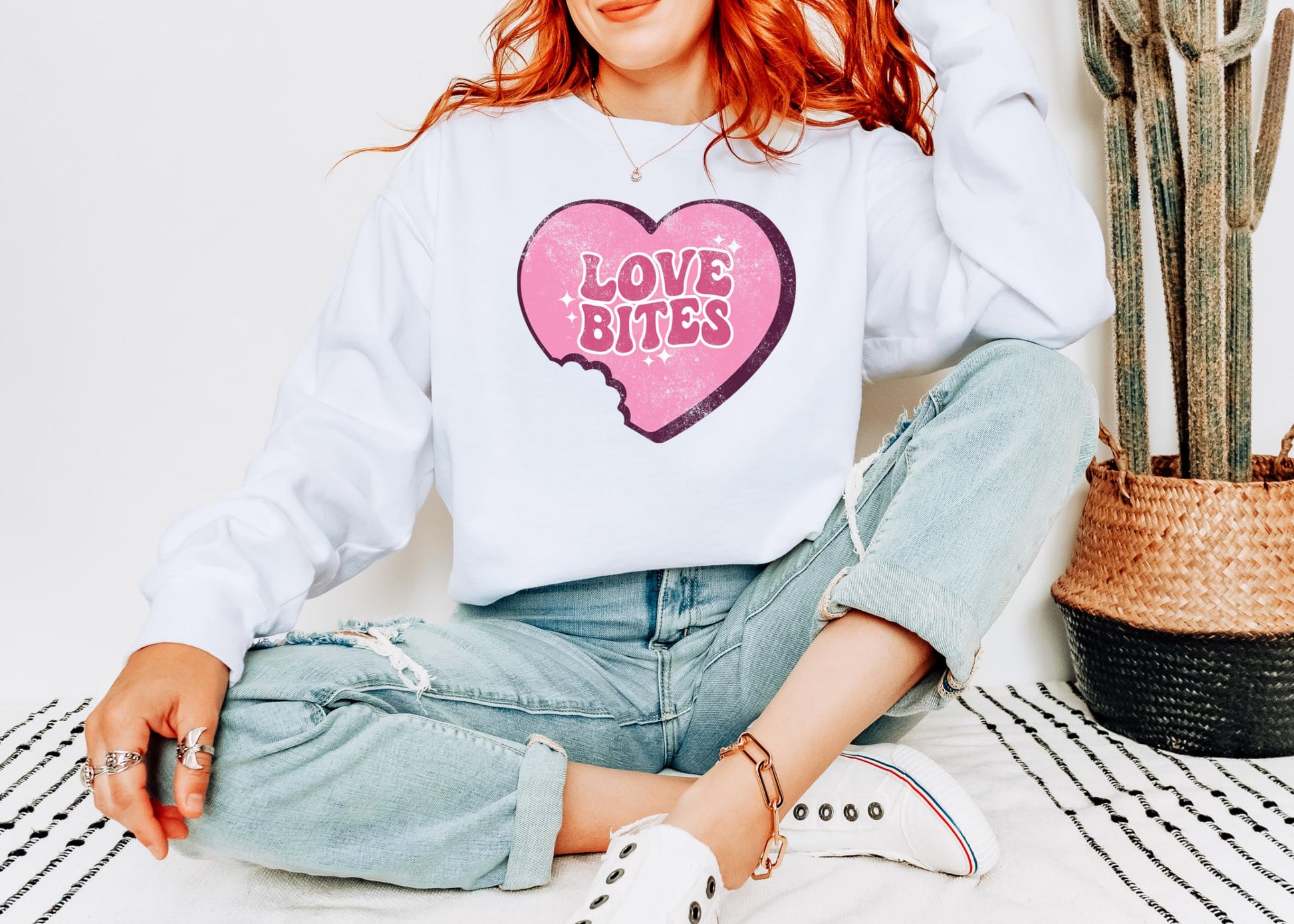 Close-up of Love Bites heart graphic print on a Valentine's Day crewneck sweatshirt