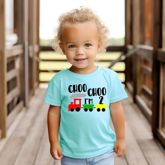 Flat lay of boys 2nd birthday train shirt showing full graphic print detail