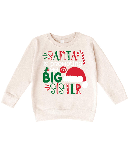 Front view of kids Christmas sweatshirt featuring a Santa 'Promoted to Big Sister' graphic design