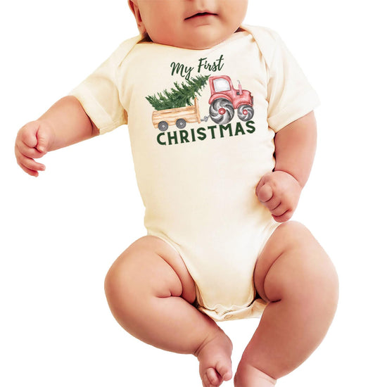 Baby boy first Christmas natural bodysuit laid flat showing full tractor and tree holiday graphic