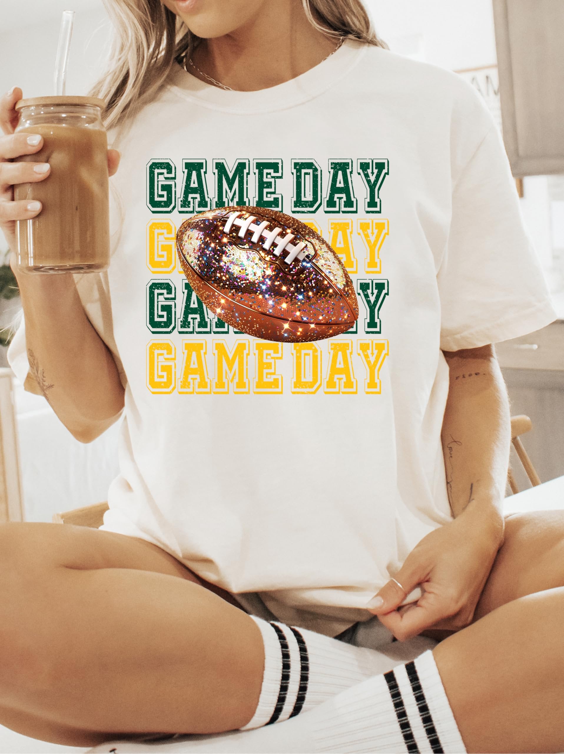 Detail shot of sparkle faux glitter Game Day football print on women's ivory tee