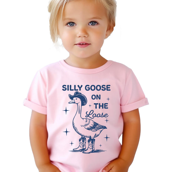 Flat lay of natural colored kids t-shirt with silly goose cowboy design