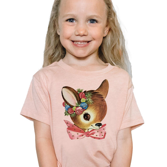 Front view of baby and toddler reindeer wreath holiday tee in peach, perfect for matching family outfits