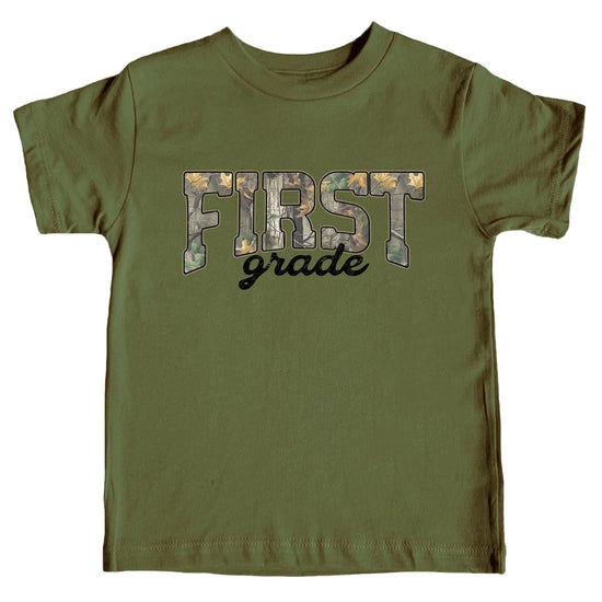 Kids First Grade camo graphic tee with bold woodland camouflage lettering by Olive Loves Apple
