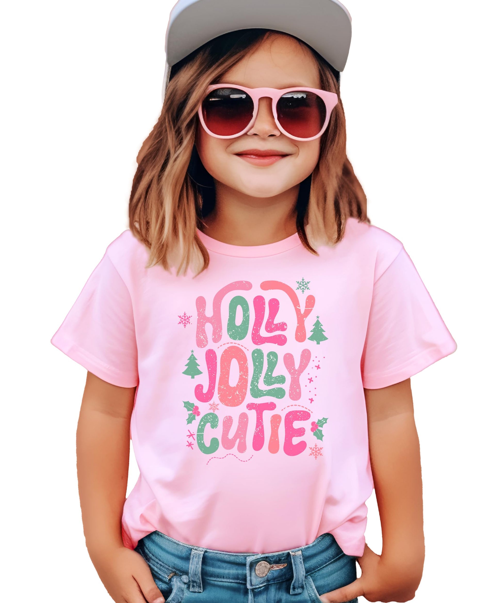 Girls' pink Holly Jolly Cutie Christmas graphic tee with candy cane lettering, Christmas trees, holly leaves, and snowflakes