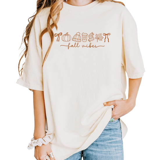 Close-up of Fall Things pumpkin and coffee graphic design print on ivory t-shirt